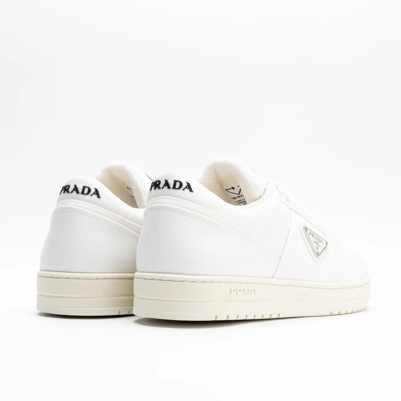 Prada Re-Nylon Sneakers Enameled Metal Triangle Logo White – voilà.id