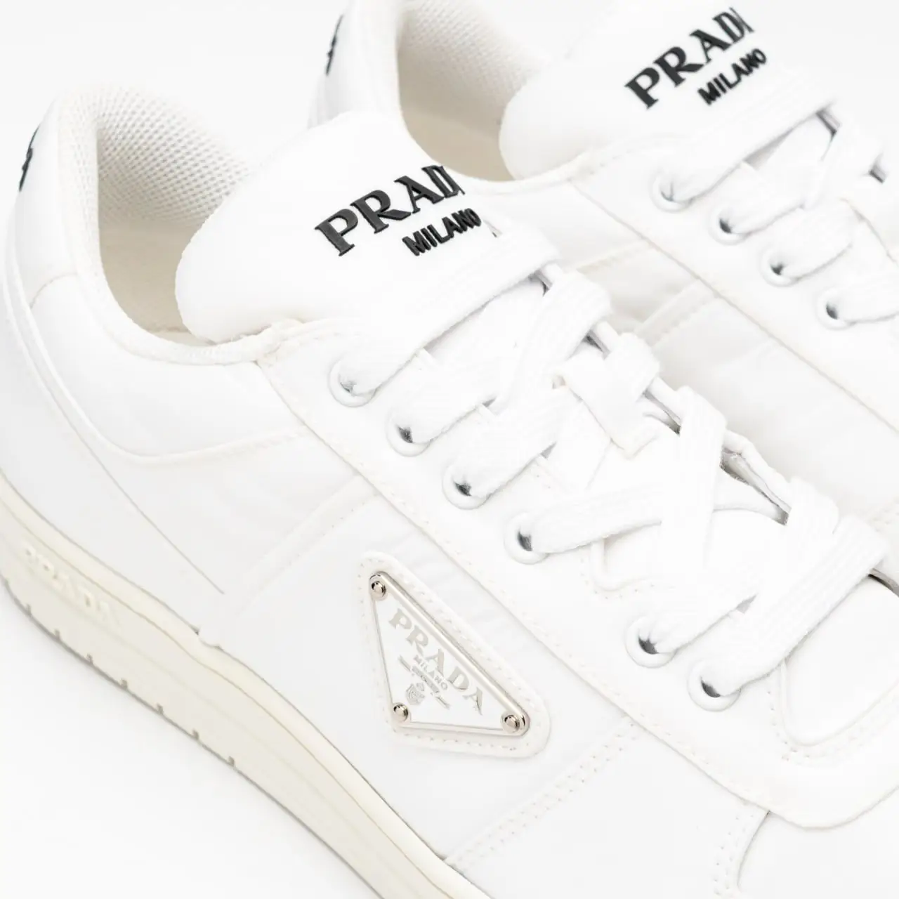 Prada Re-Nylon Sneakers Enameled Metal Triangle Logo White – voilà.id