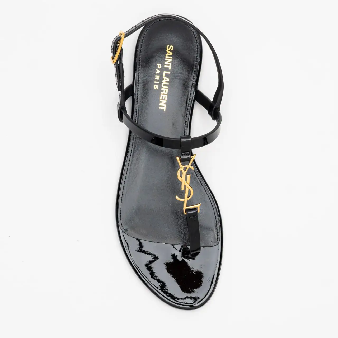 サンダル・ミュール [ SAINT LAURENT]PATENT LEATHER CASSANDRA FLAT SANDALS Saint Laurent Cassandra Leather Flat Sandals in Nero | FWRD